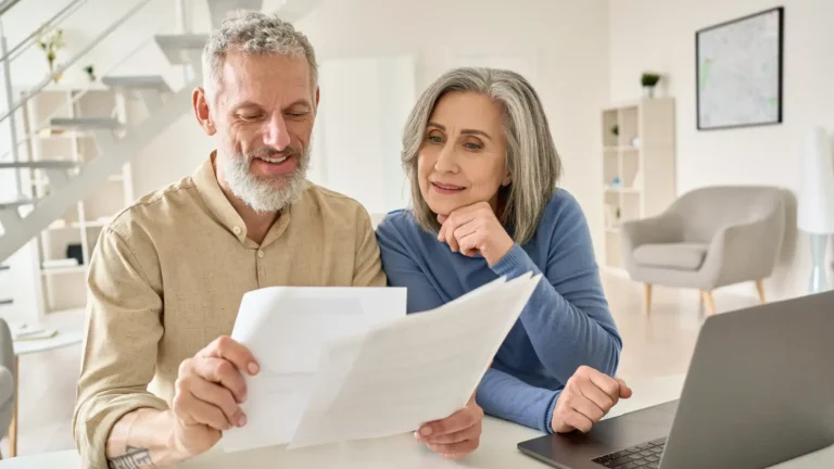 An elderly couple reading documents